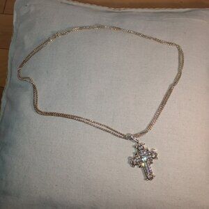 Rhinestone cross on a gold tone double chain necklace.